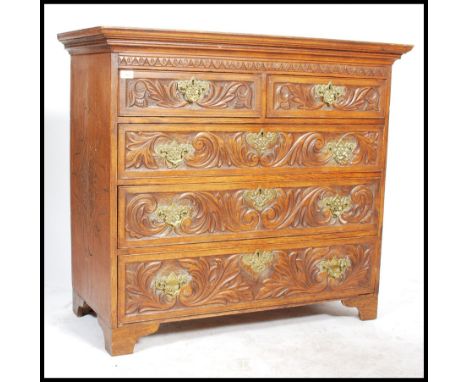 A 19th Century country oak chest of drawers, two short drawers over three long drawers, swag drop brass handles raised on bra