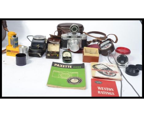 A vintage 20th Century cased Braun Super Paxette Outfit. Comprising camera with lenses, various accessories to include filter