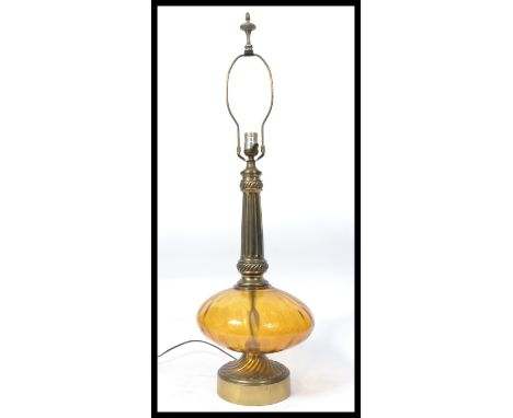 A vintage retro glass and brass table lamp in the manner of Murano, brass circular base with a bulbous amber glass section su