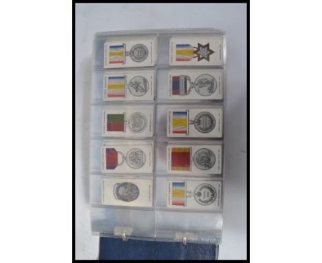 An album of vintage cigarette cards mainly full sets to include Players decorations and medals never issued , Churchmans boxe