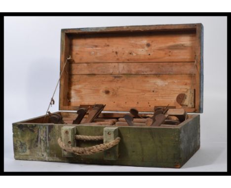 A large collection of vintage 20th century woodworking tools and planes all held within a vintage wooden tool box with rope h
