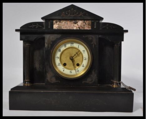A Victorian polished slate mantel clock with enamel and gilt metal dial. The brass 8 day movement with slate and marble case 