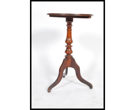 A 19th century early Victorian solid mahogany wine / lamp table raised on tripod base with circular top above. 75x45 diameter