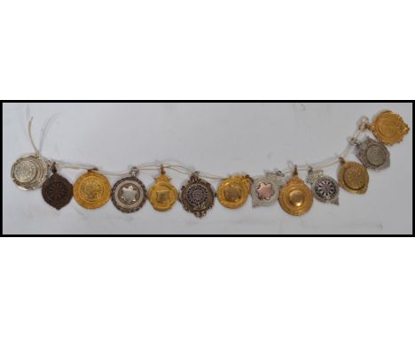 A collection of vintage 20th century silver hallmarked and silver plated fob medals some with gold detail. Measures 3 cm diam