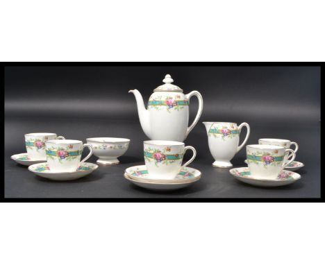 A Royal Doulton Estelle pattern tea service with printed floral bouquets within blue borders. Consisting of tea pot teapot , 