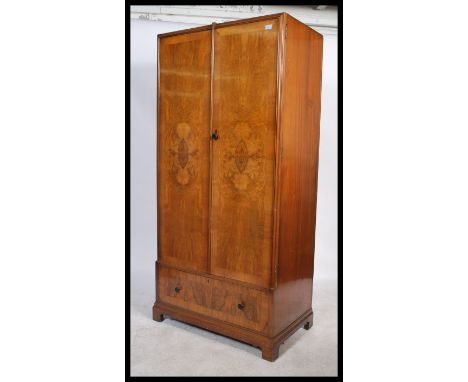 A 1930's Art Deco walnut single wardrobe&nbsp; armoire in the manner of Compactom. The robe being raised on bracket feet with