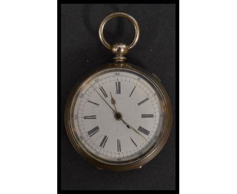 A vintage early 20th century silver white metal pocket watch having a white enamel face with roman numeral chapter ring and f