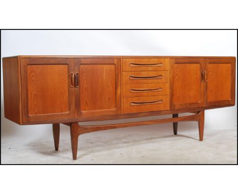 A G-plan vintage 20th century retro teak 'Fresco' sideboard with four central drawers flanked by four cupboard doors, raised 