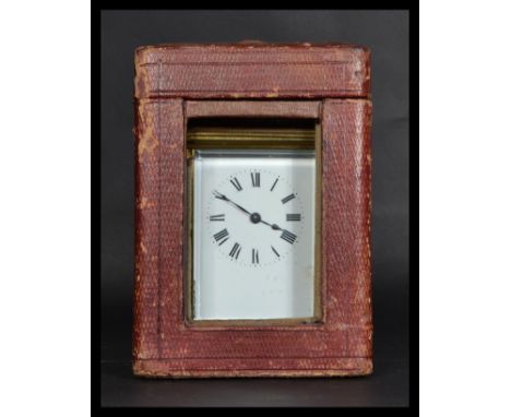 An 19th century brass carriage clock with inset French movement. Enamel face with roman numeral chapter ring and faceted hand
