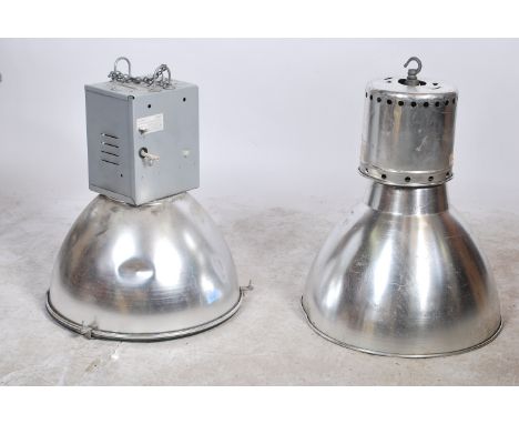 A pair of large industrial vintage mid 20th century aluminium ceiling lights of domed circular down lighter form, each with i