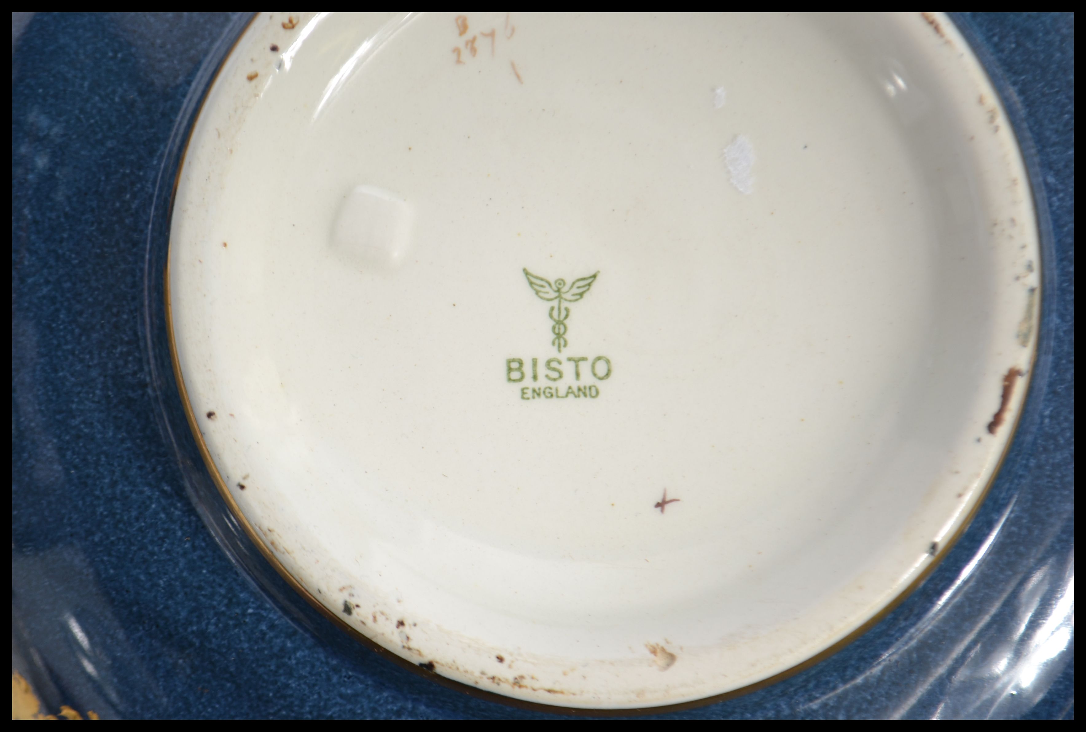 An early 20th century Bisto ware ceramic bowl having a deep blue ground