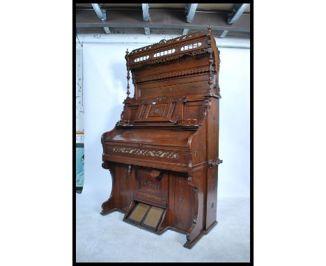 A late Victorian 19th century chapel harmonium organ. The case with simple carved detail, moulded outline and raised gallery 