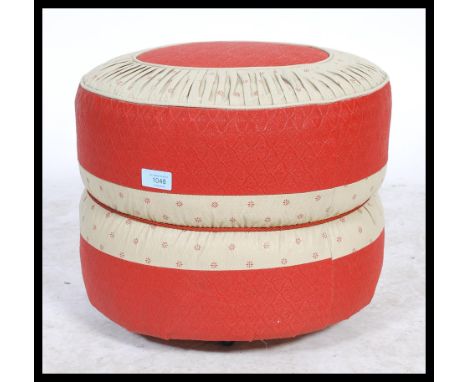 A retro mid century two tone vinyl panel stitched pouffe, having a geometric design to the top and applied makers label Hanle