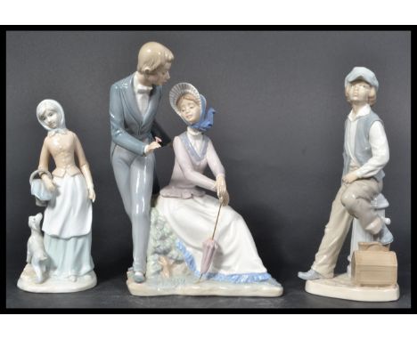 A collection of 2 Nao figurines to include gentleman and lady with umbrella, boy sat on pedestal and another of a maiden, pos