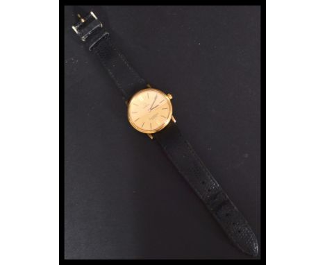 A vintage 20th century Omega Constellation swiss made wrist watch. The gilt dial having baton and roman XII and VI numerals.