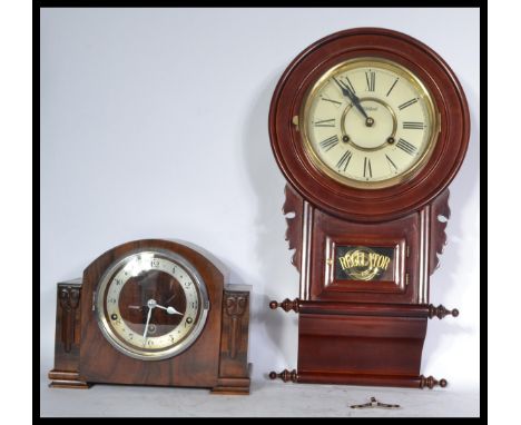 Two vintage clocks one being and Art Deco mantle clock of square form and the other being a 20th century Regulator wall clock