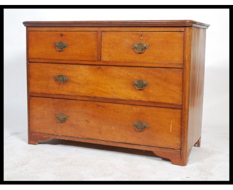 A Victorian early 20th Century mahogany two short over two long chest of drawers having a flat flared top with swag and swan 