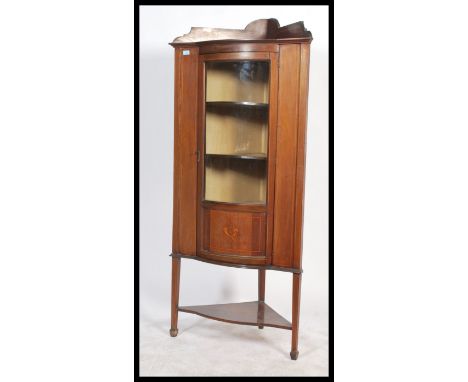 Edwardian inlaid mahogany corner display unit on tapering support with two internal shelves and a lower shelf, the glazed doo