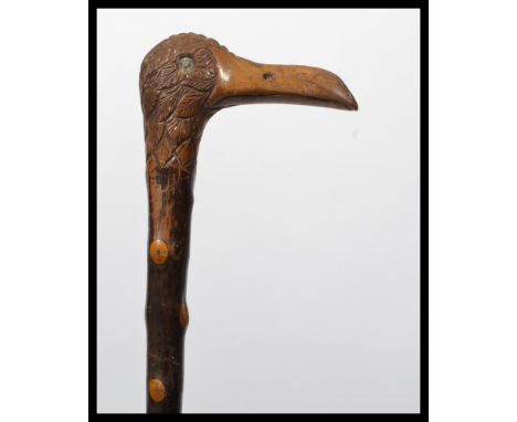 A vintage early 20th century walking stick cane having a tapering blackthorn shaft. The handle carved as an albatross bird he