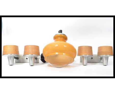 A retro vintage pair of twin conical wall sconces formed for aluminium with spun strip shades together with a retro amber gla