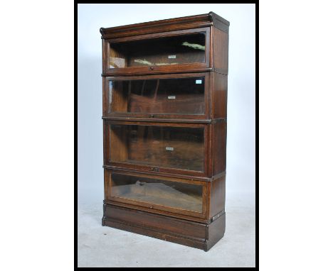 An Edwardian solid oak&nbsp; 4 section /&nbsp; tier lawyers - barristers stacking bookcase cabinet by&nbsp; Globe Wernicke. T