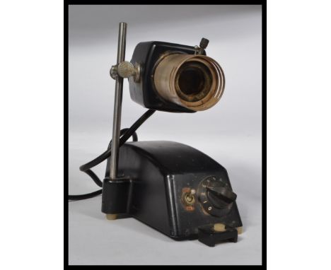 An unusual mid 20th century retro scientific / Industrial projector lamp with raised lamp on metal black plinth base with dia