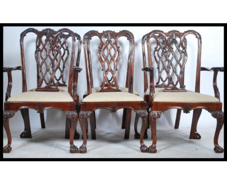 A set of six Chippendale-style mahogany dining chairs, 20th century, each with pierced and scroll carved splat back, over dro