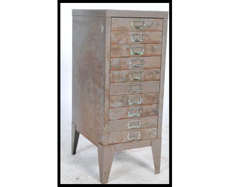 A vintage / retro industrial upright metal eight short drawer filing cabinet, shaped supports having notation slides and loop