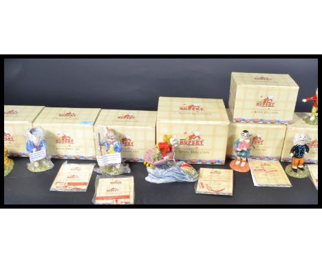 A collection of seven boxed Royal Doulton Rupert The Bear figures to include Edward Trunk pretending to be an outlaw RUBESC14