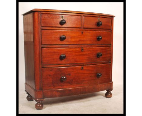 A Victorian mahogany bow front chest of drawers. Being raised on turned legs with a 2 short over 3 deep configuration, all dr