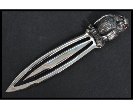 A sterling silver bookmark having a bird finial handle with inset ruby eyes. Weighs 10 grams.