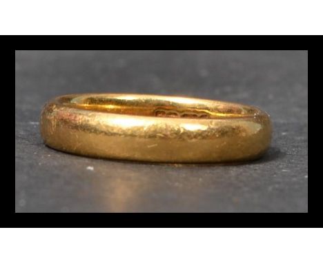 A hallmarked 22ct gold wedding band ring. Size L weighs 5.7 grams.  