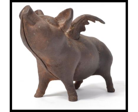 A vintage 20th Century cast metal pig ( Pigs might fly ) with wings money box, wings outstretched with slot to the top.