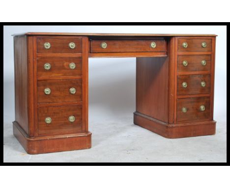 A good Victorian mahogany inverted breakfront twin pedestal desk with tooled red leather skiver, the drawers with ring drop h