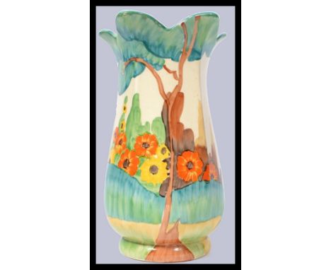 A 1930's Clarice Cliff Bizarre 361 shape vase hand painted with hills and flowers in the Fragrance pattern with tree leaves c