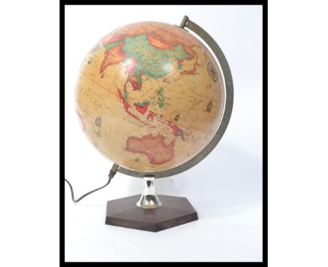 A retro 20th century illuminated terrestrial desk top globe raised on a pedestal base, the globe bearing the manner of Stella