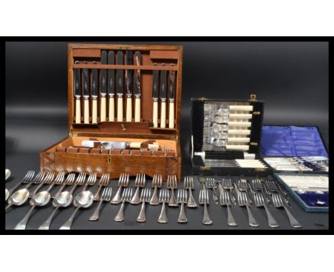 A vintage 20th century oak cased canteen of cutlery together with cased flatware to include a stunning set of silver plated A