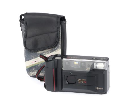 black, body F-G, battery door spring needs to be glued back in place, powers up, flashes, takes a shot, has Carl Zeiss Tessar