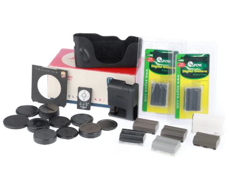 to include empty packaging for a Leica Telyt lens, a Linhof lens board, and a number of camera rechargeable batteries.
