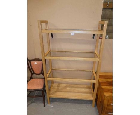 A light oak four tier bookcase with glass shelf inserts