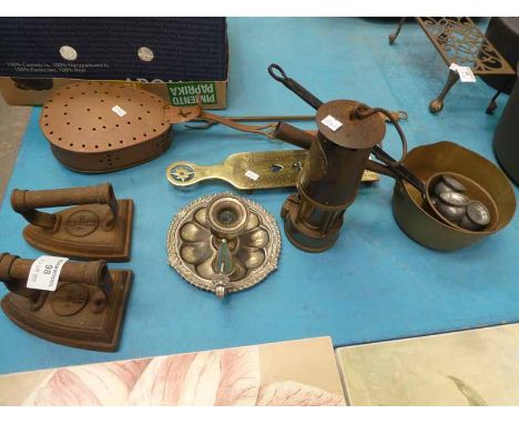 Twelve items of metalware to include Eccles miners lamp, flat irons, cribbage board, brass pan etc 