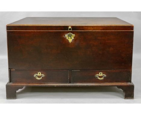A mid 18th century mahogany mule chest, with moulded hinged top and two drawers below, having brass side carrying handles, on