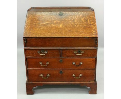A George II oak bureau, with a moulded three quarter gallery, the later hinged fall enclosing a well with sliding cover, step