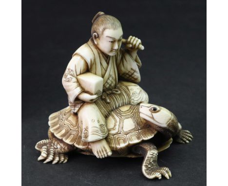 A Japanese ivory okimono of a man, Meiji period, carved seated on the back of a turtle, holding a stick and box, signed, 6cm 