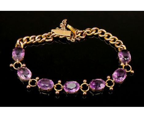 A 9ct gold and amethyst-set bracelet, with seven amethysts, the clasp detailed 9ct, 8.4g gross.