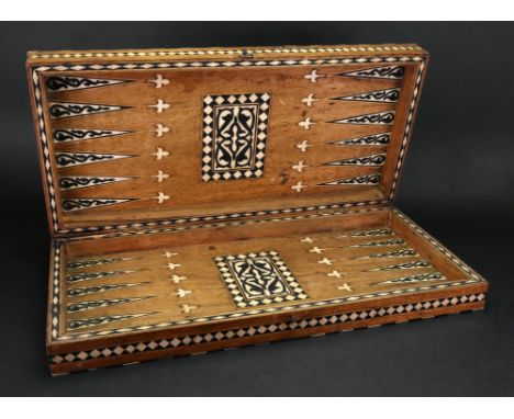 An ivory and hardwood inlaid games board, Ottoman Provinces,19th century, the outside arranged as a chessboard, the black squ