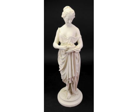 A Worcester Parian figure of a classical woman, mid 19th century, modelled standing in long robes, carrying a nest of chicks 