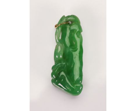 A carved green jade pendant, 20th century, of abstract form, 7g gross.