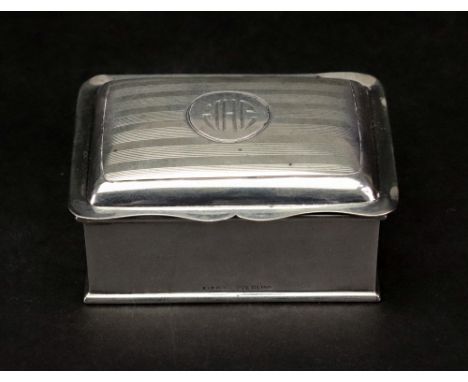 A Canadian rectangular stamp box, Birks, detailed sterling, the hinged engine turned cover enclosing two divisions, gilt line