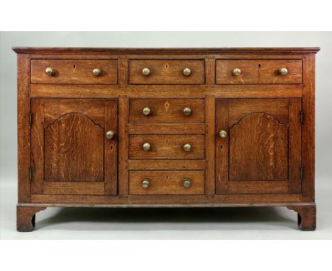 A George III oak dresser, the rectangular top above three frieze drawers with three central drawers below flanked by a pair o